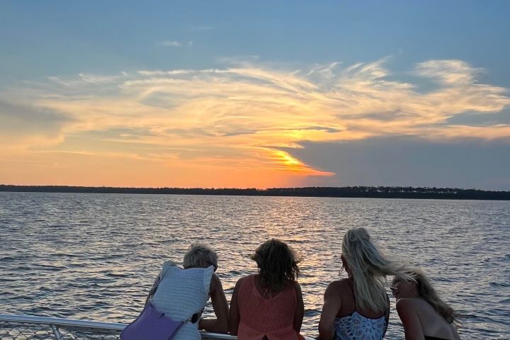 a group of people standing next to a body of water