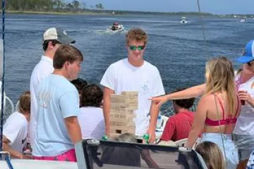 a group of people in a boat on a body of water