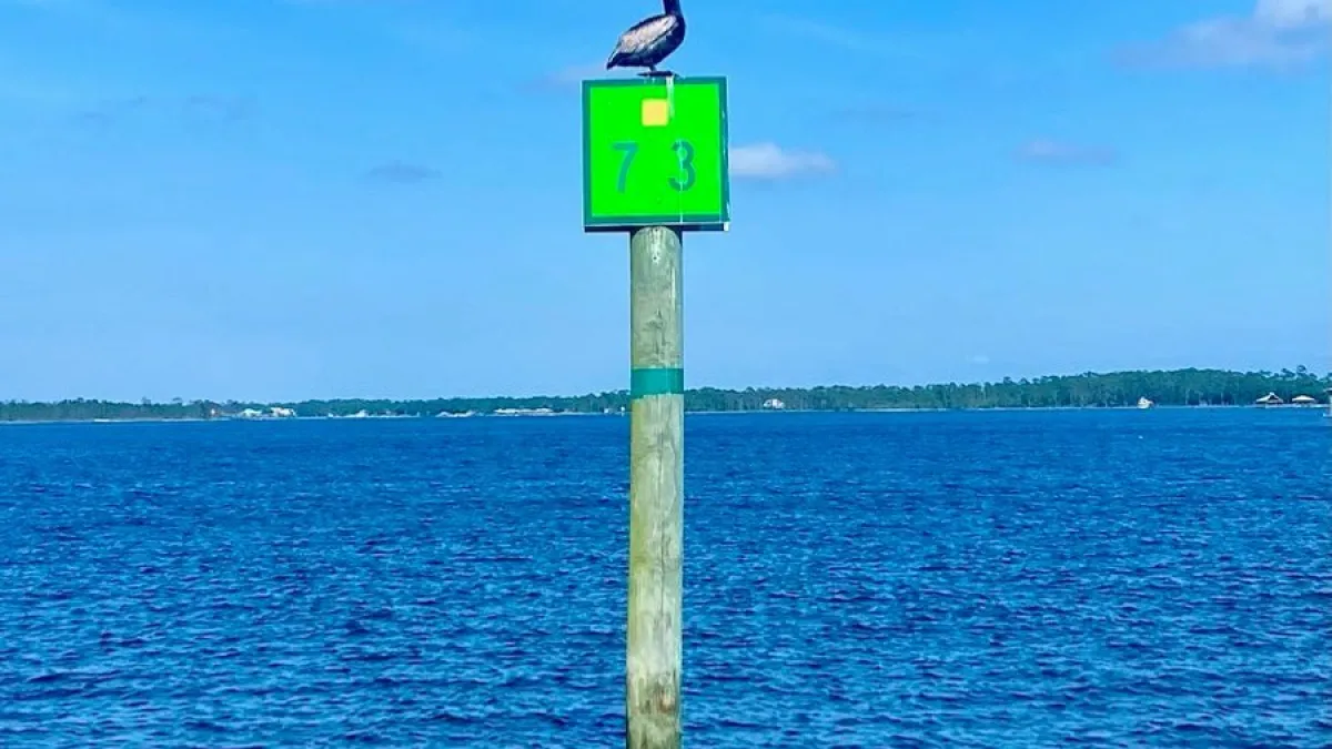 a sign above a body of water