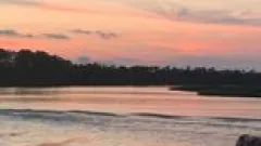 a man standing in front of a sunset