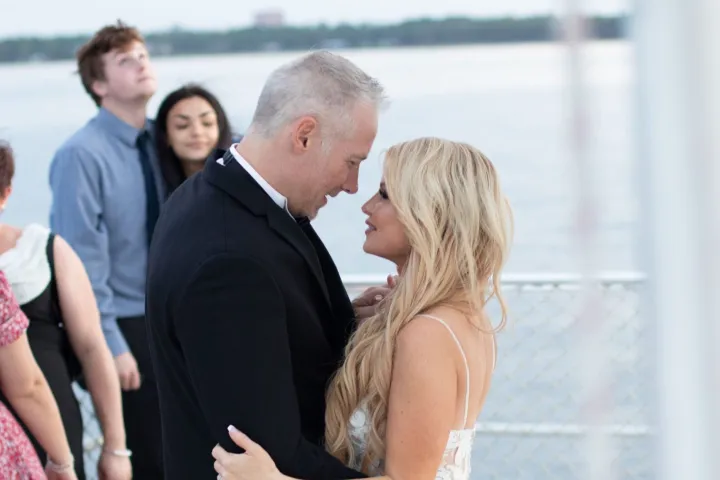 a couple of people that are standing in a wedding dress