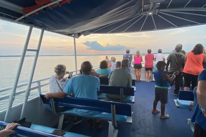 a group of people sitting at a dock