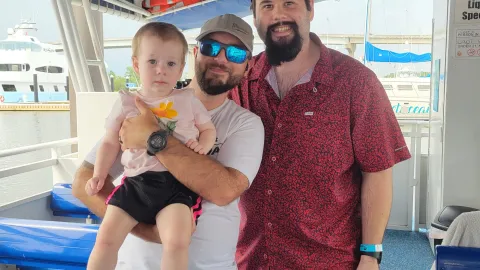 a group of people standing in front of a boat