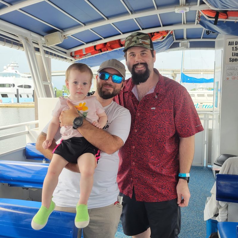 a group of people standing in front of a boat