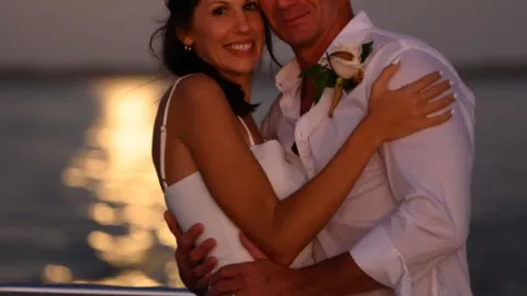 a man and a woman looking at the camera