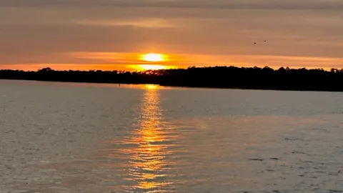 a sunset over a body of water