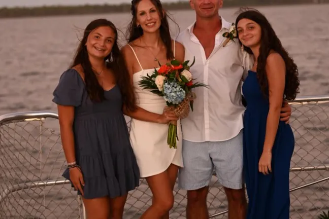 a group of people on a beach posing for the camera