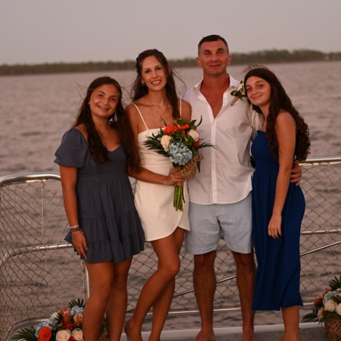 a group of people on a beach posing for the camera