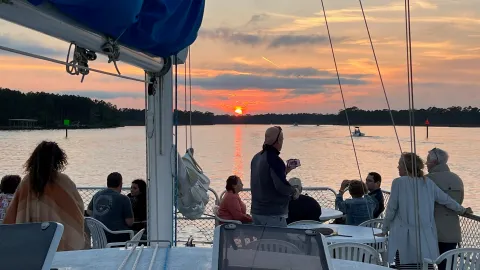a group of people sitting at a dock