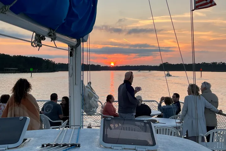 a group of people sitting at a dock