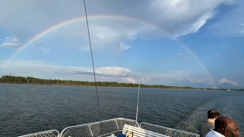a group of people standing next to a body of water