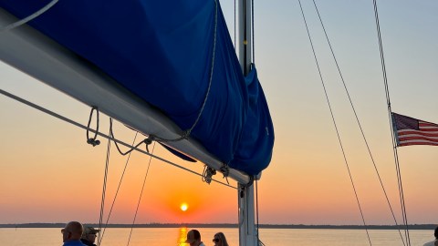 a group of people sitting at a dock
