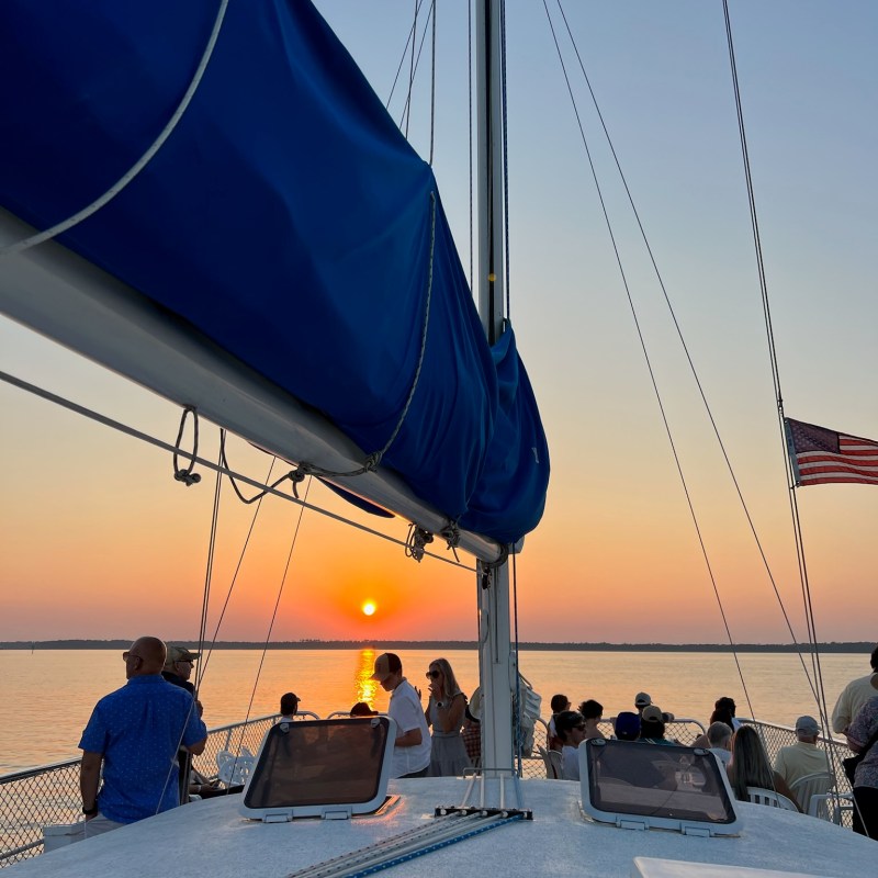a group of people sitting at a dock